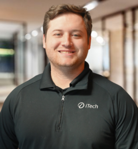 Ethan Williams Smiling man in black polo with iTech logo.